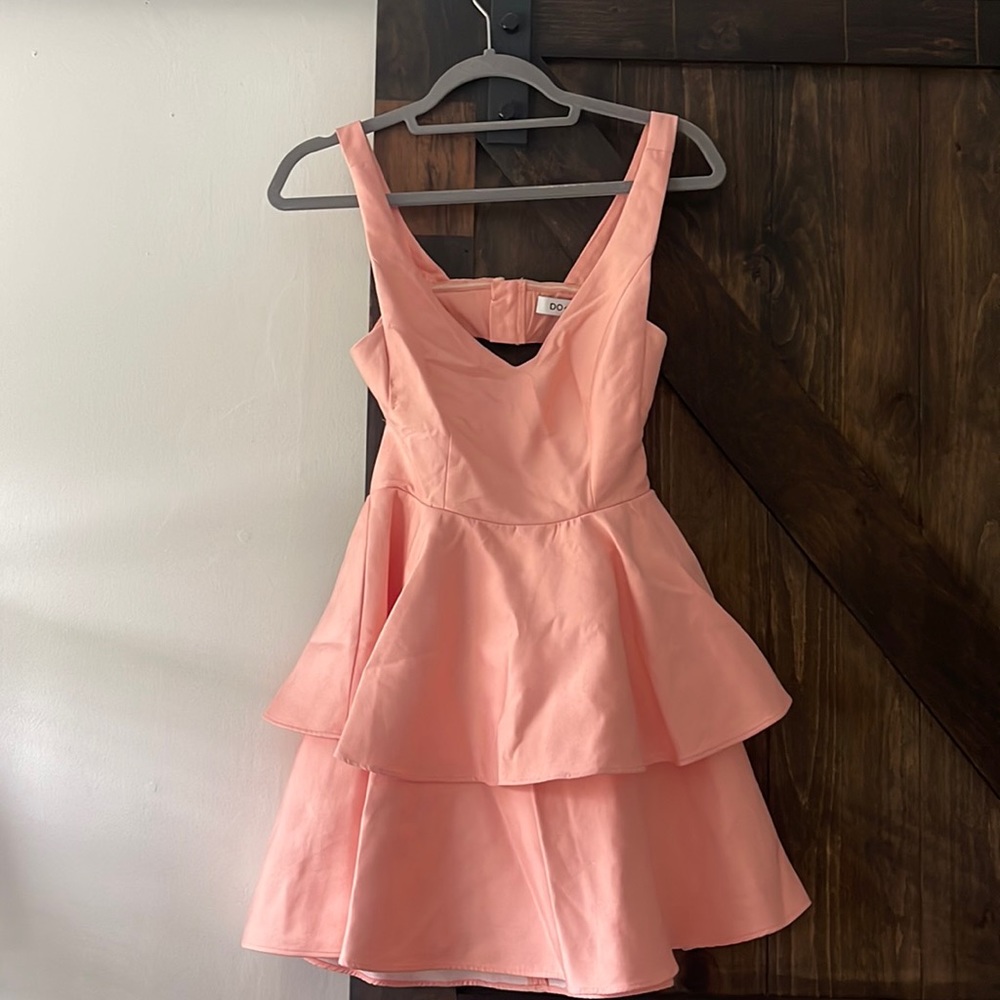 A coral backless dress perfect for summer weddings or a homecoming dance!